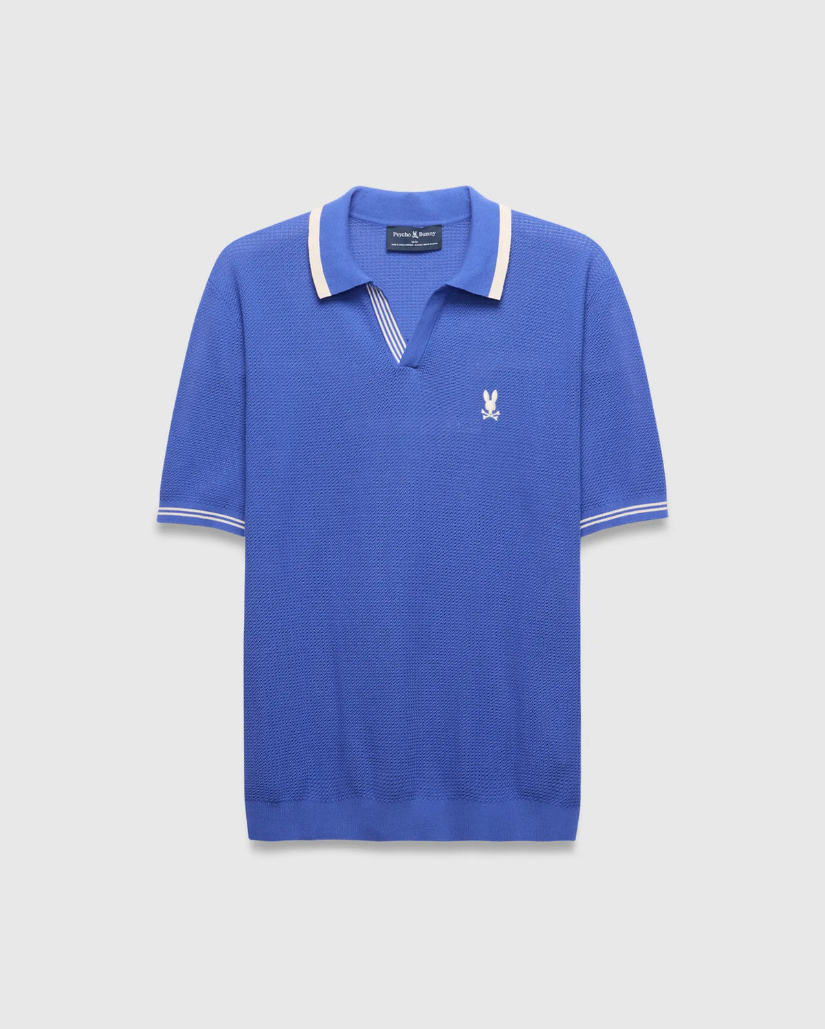 Mens Innis Polo, classic fit, vibrant blue pique knit with cream striped V-neck collar and cuffs, featuring a small embroidered white Psycho Bunny skull logo on the left chest.